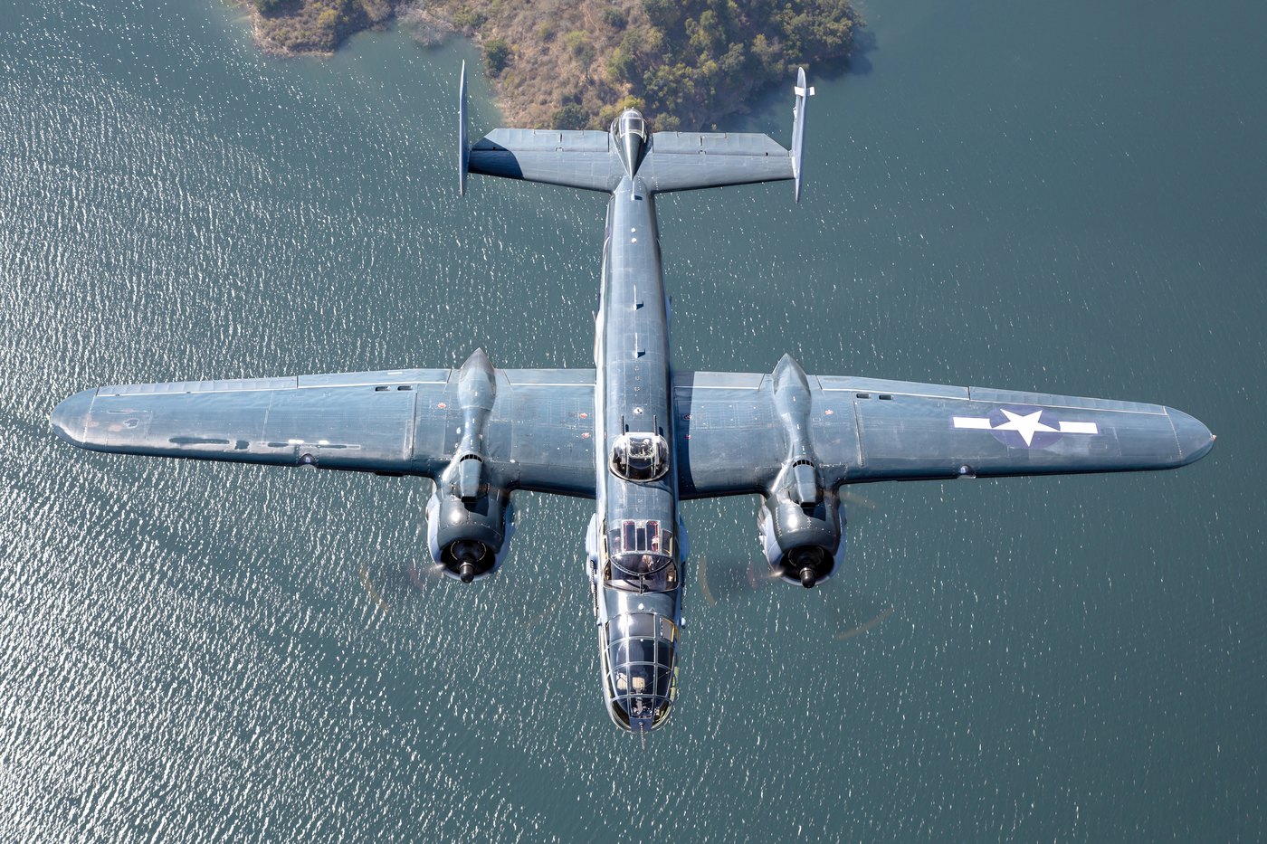 PBJ-1J Mitchell N5865V photographed from directly above over water, showing the wing planform and twin fins