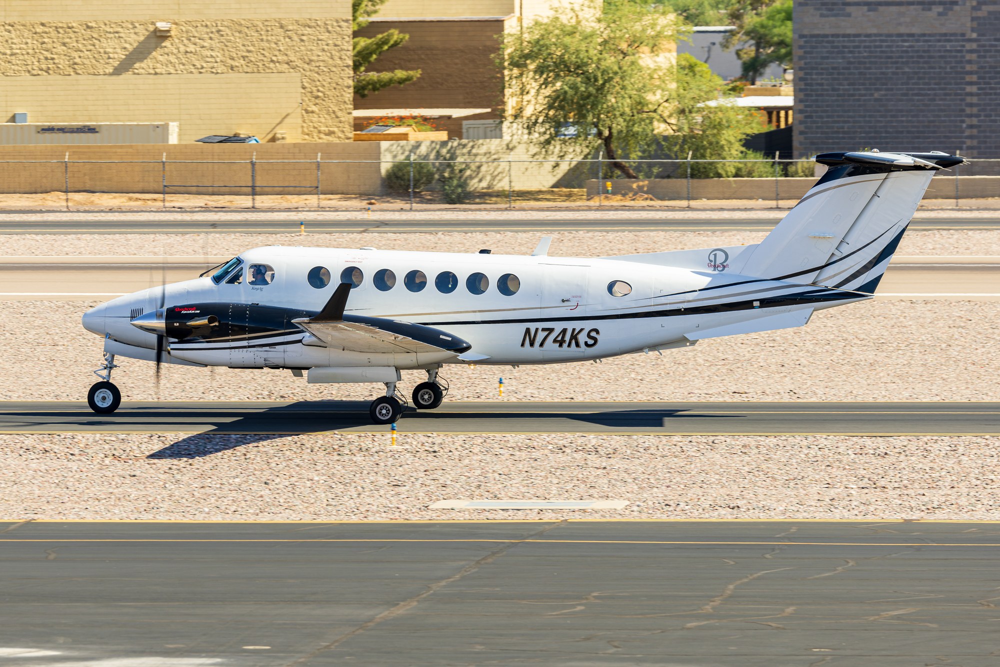 Beechcraft King Air N74KS taxiing at Scottsdale with heat shimmer visible behind it