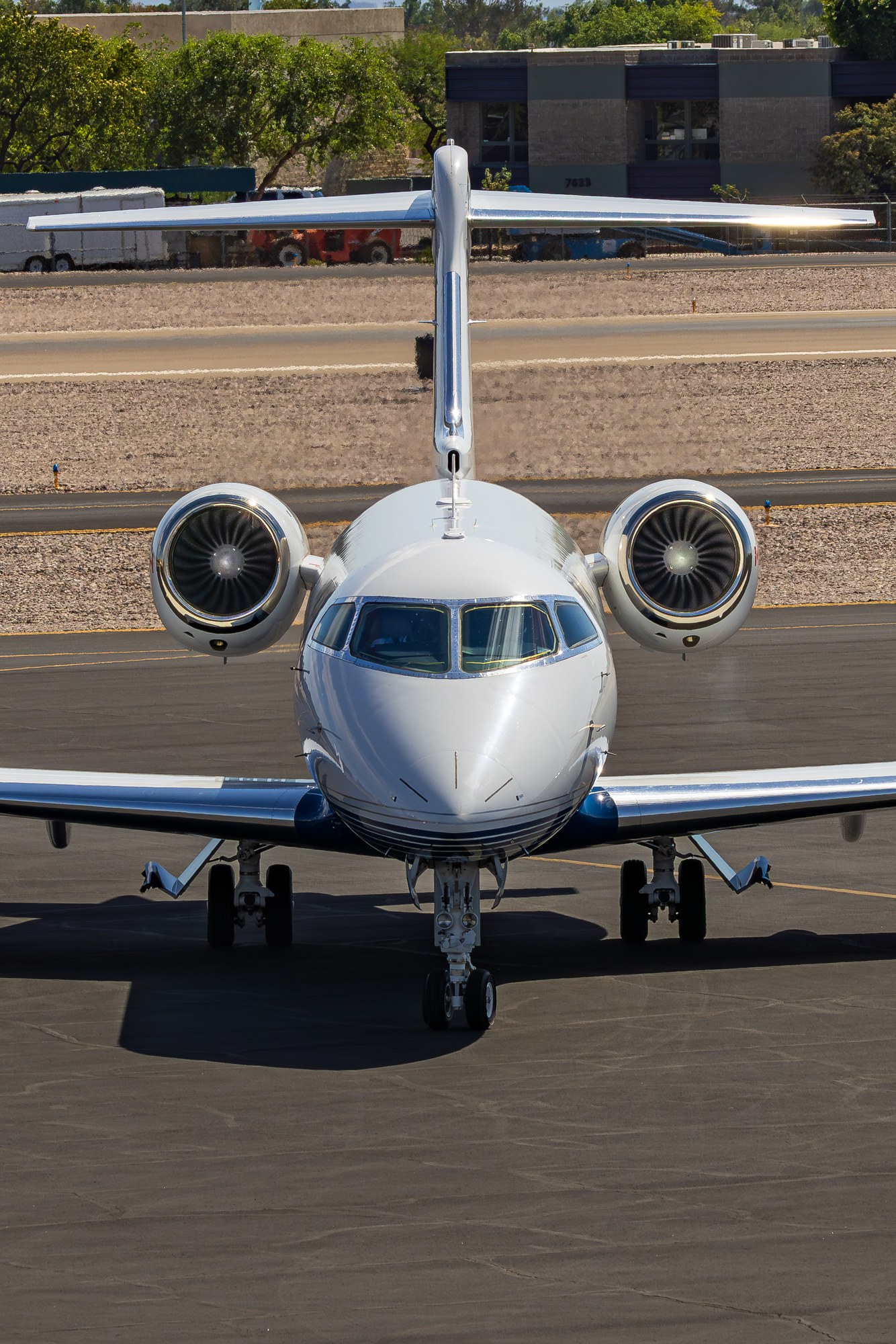 A business jet taxiing head on towards the camera at Scottsdale Airport