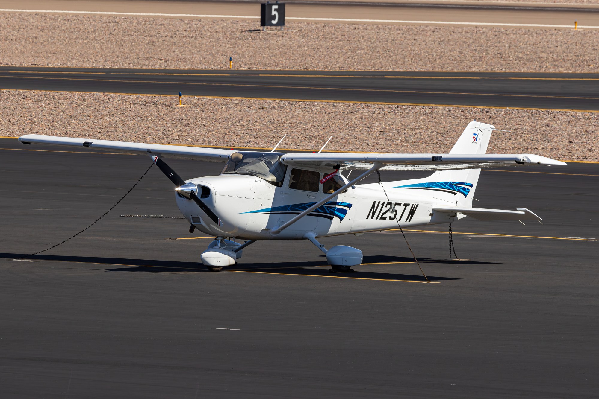 Cessna 172 N125TW chained down on the ramp at Scottsdale Airport