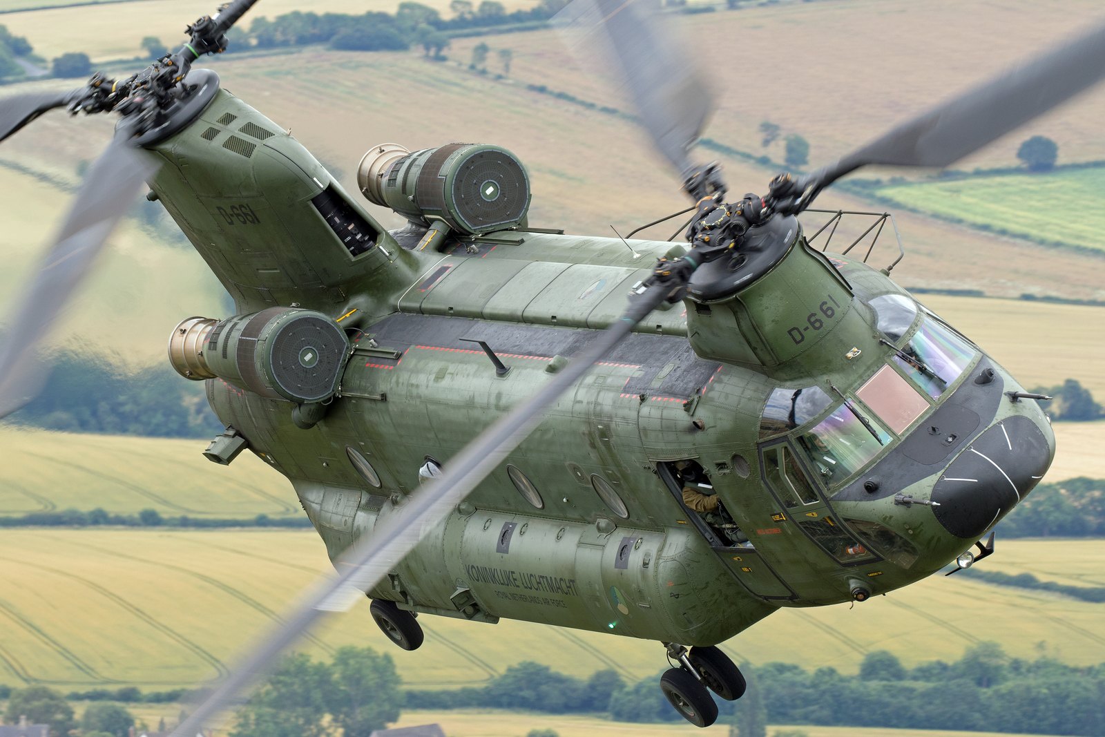 Close-up of a Royal Netherlands Air Force CH-47D Chinook from above, showing both engines beside the rear pylon and an open crew door