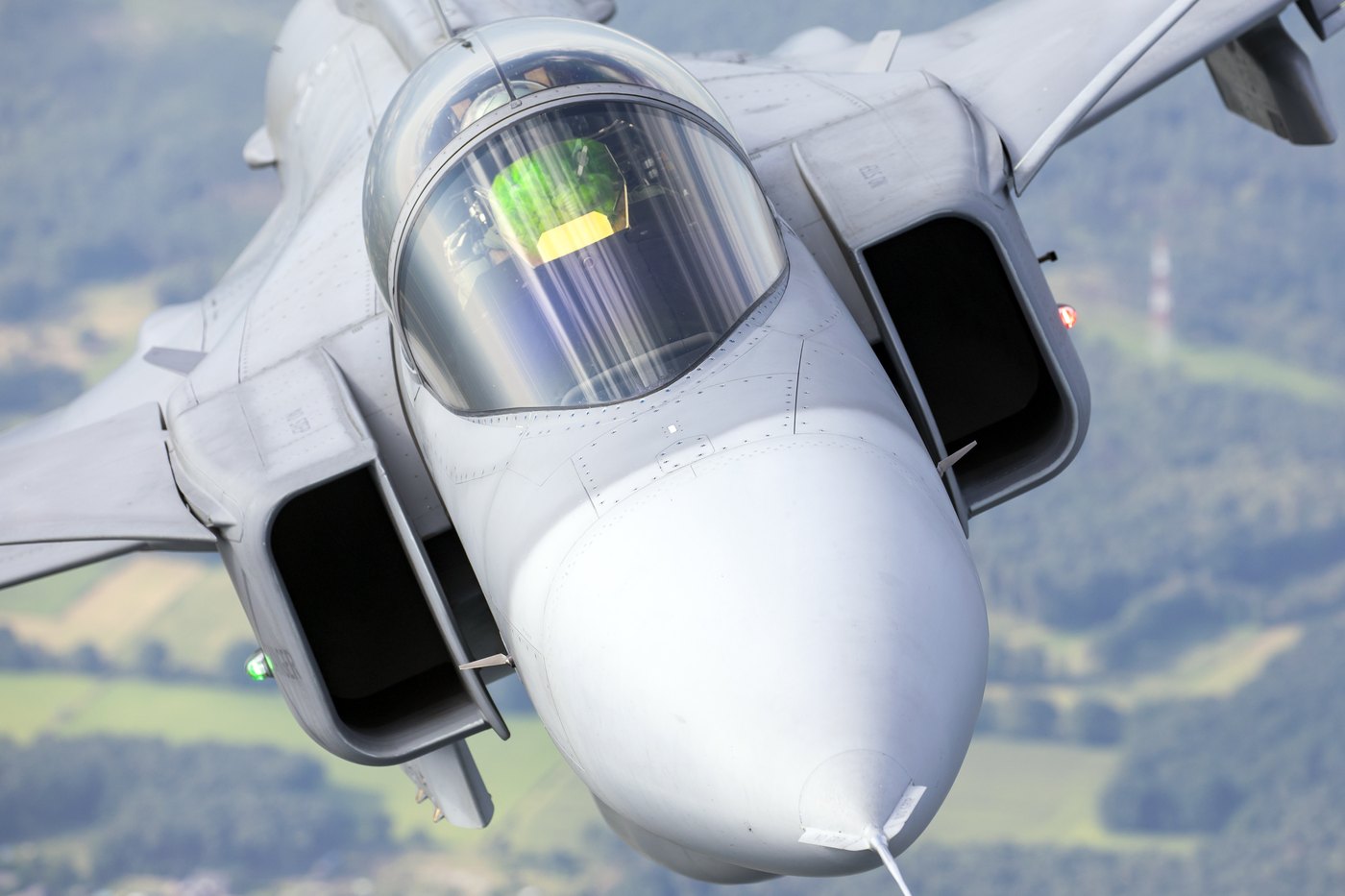 Close overhead view of a Czech Air Force Saab JAS 39C Gripen, showing the nose, the air intakes and the head-up display glass in front of the pilot