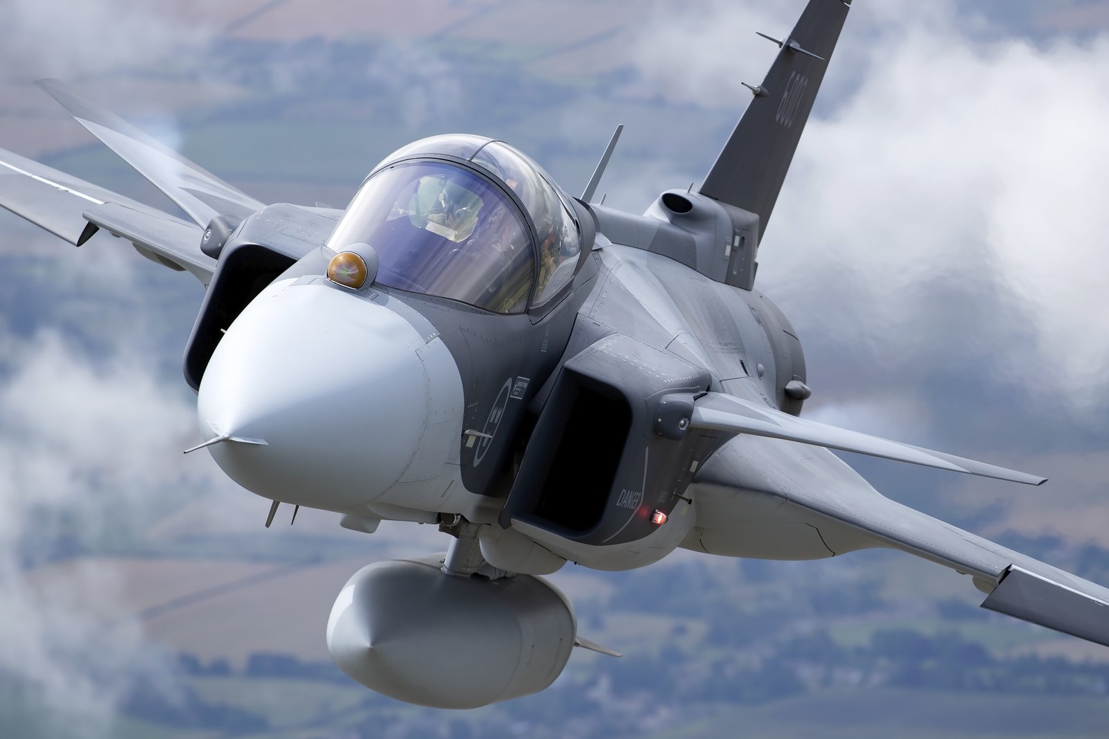 A close-up of a Saab JAS 39E Gripen of the Swedish Air Force in flight, showing the canard foreplane and the nose sensor
