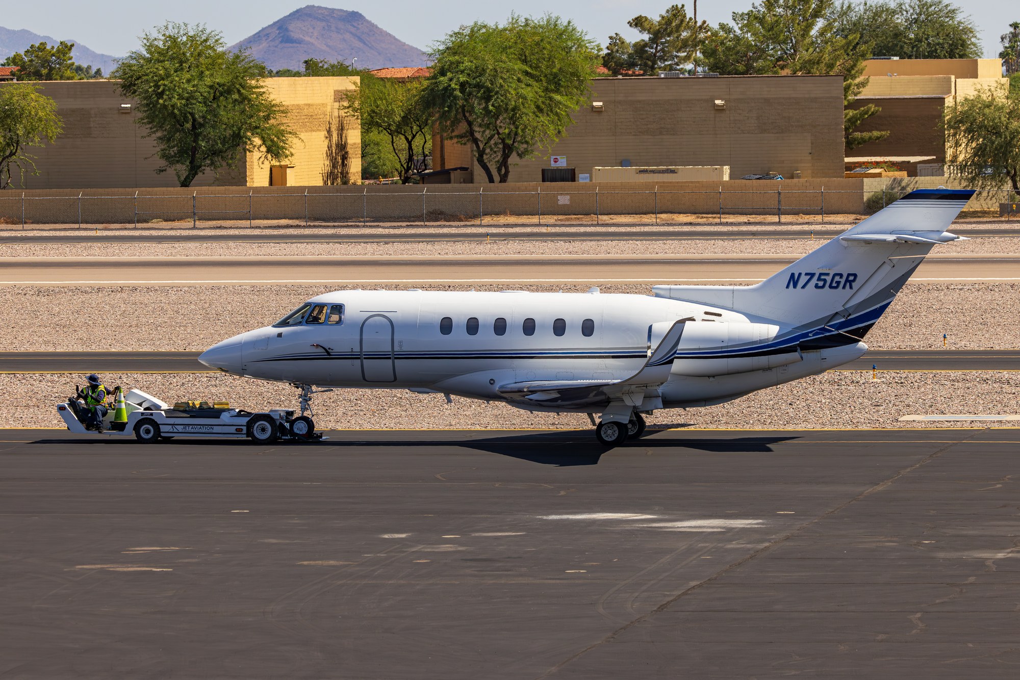 Hawker N75GR being towed by a Jet Aviation tug at Scottsdale Airport