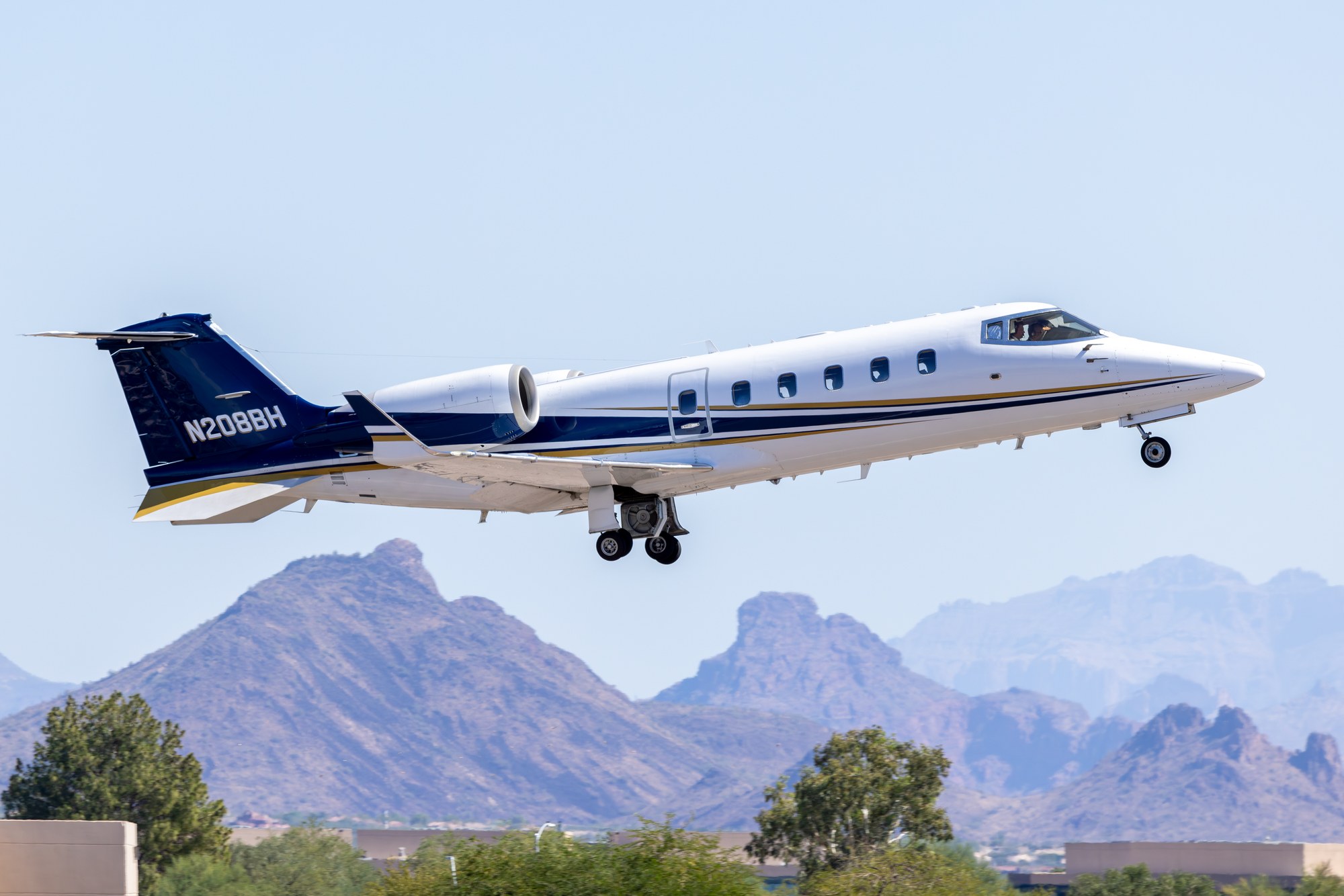 Learjet N208BH climbing away from Scottsdale with the Arizona mountains behind