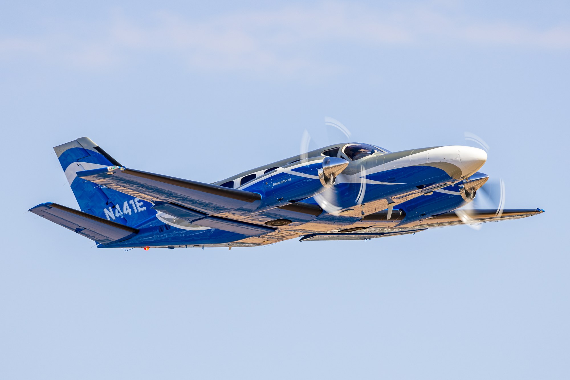 Twin turboprop N441E marked Propjet Dash 10 climbing away from Scottsdale with propellers blurred