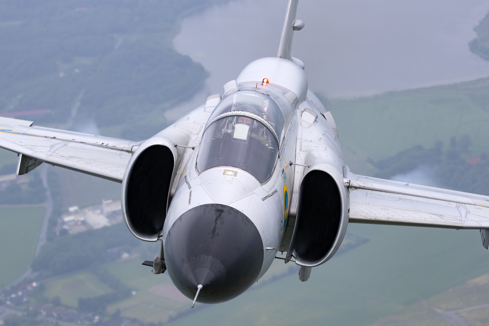 A Saab AJS37 Viggen of the Swedish Air Force Historic Flight seen head on from above, showing the canard foreplanes and double delta wing