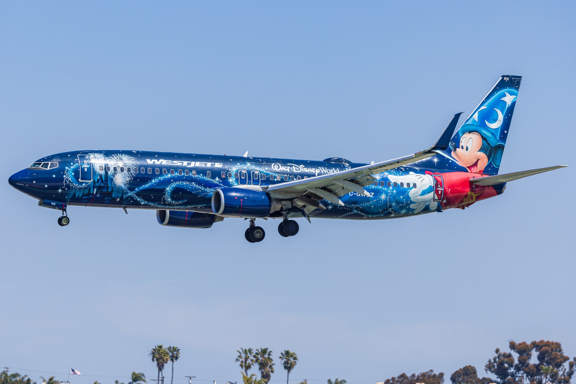 WestJet Boeing 737-800 in the blue Walt Disney World Magic Plane livery on approach to San Diego